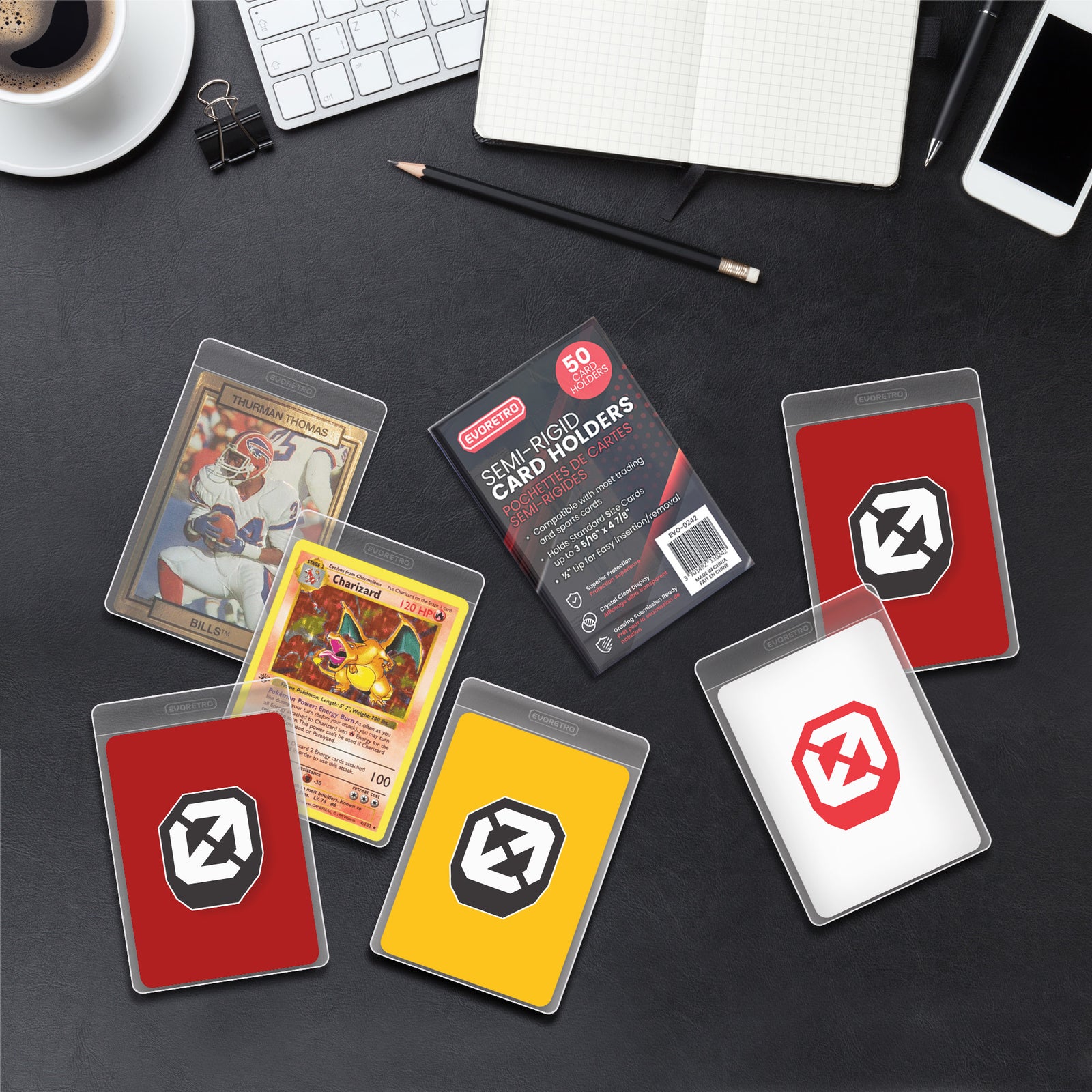 Collection of trading cards in protective cases on a desk with office supplies.