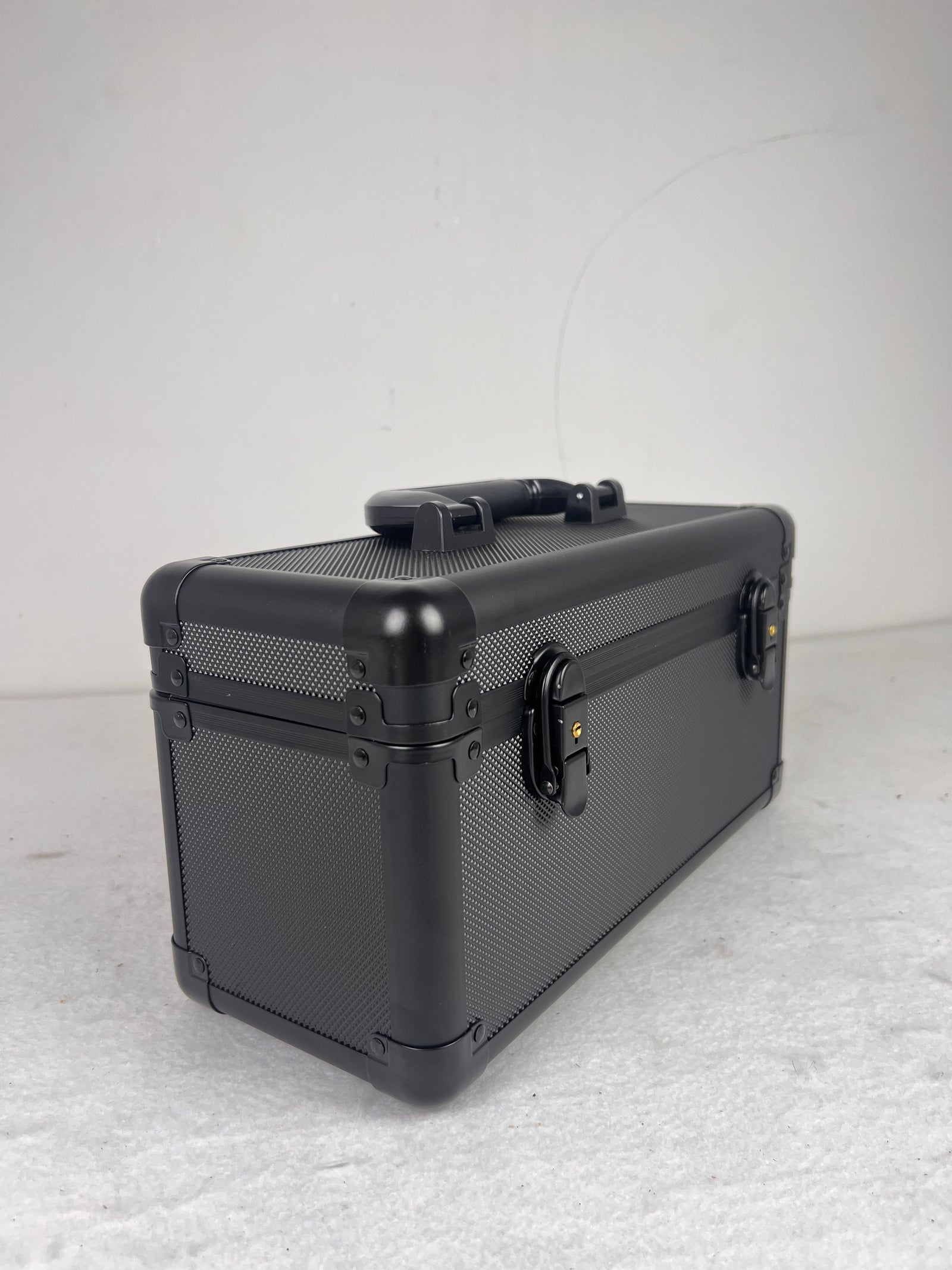 Black - grey suitcase on a light gray background