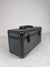 Black - grey suitcase on a light gray background
