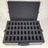 Black foam-lined storage case with compartments on a white background