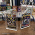 EVORETRO acrylic booster pack cases displaying sealed Pokemon and YuGiOh packs on table