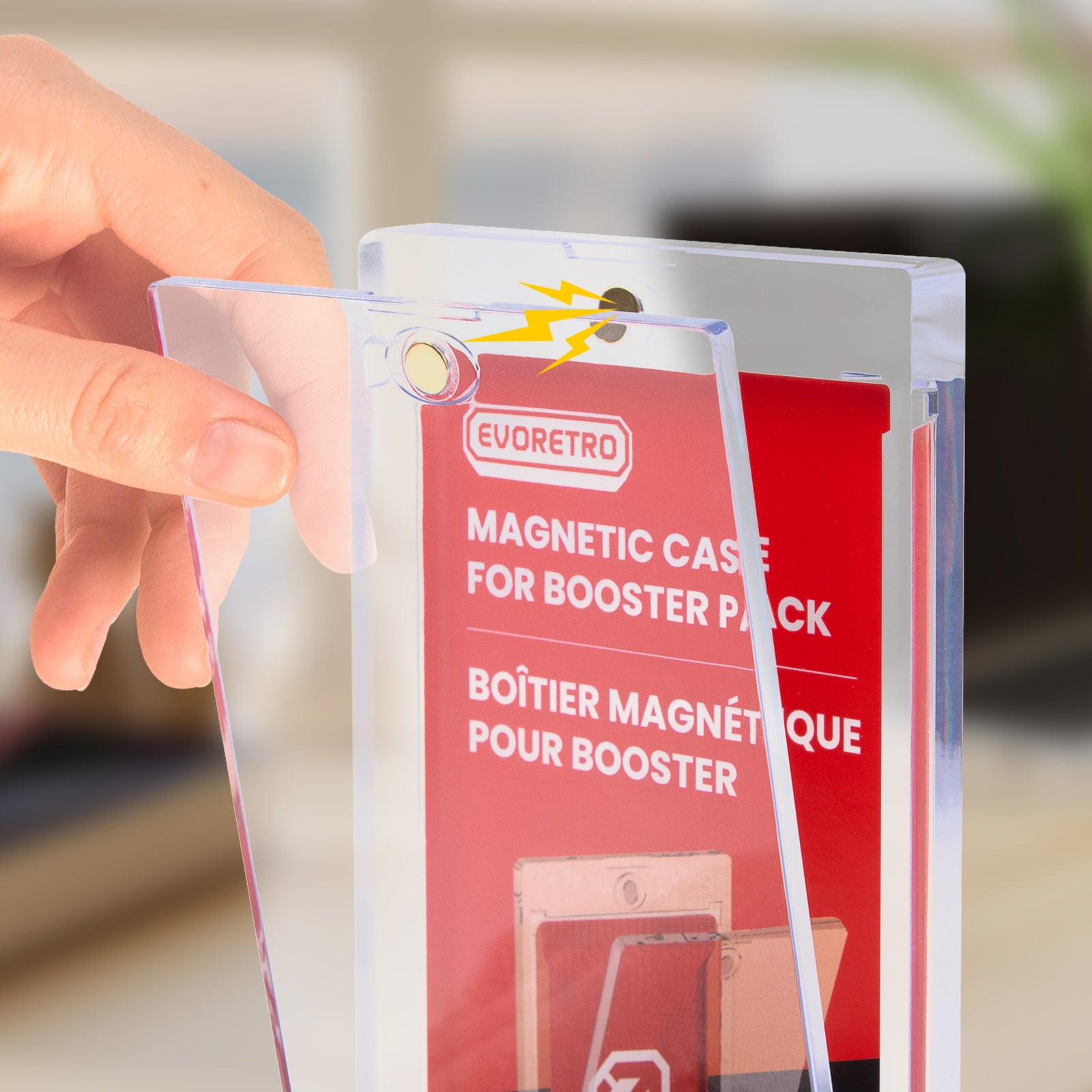 Hand holding EVORETRO clear magnetic booster pack case packaging with red label.