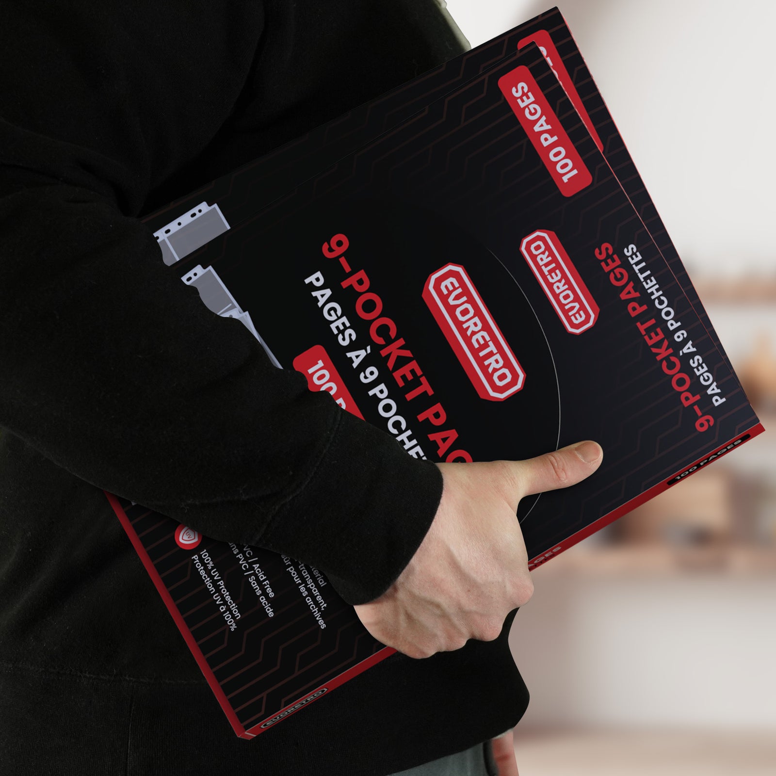 Person holding a black and red EVORETRO 9-pocket page packaging