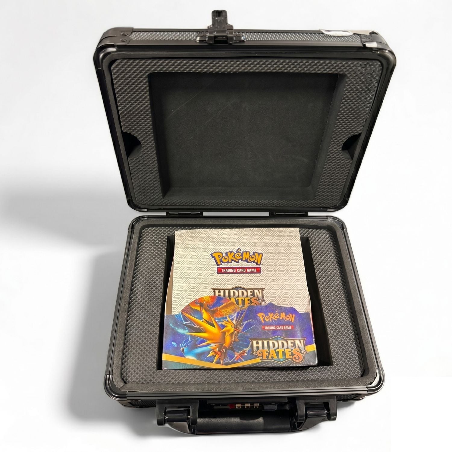 Black protective case with a Pokémon trading card game book titled 'Hidden Fates' on a white background