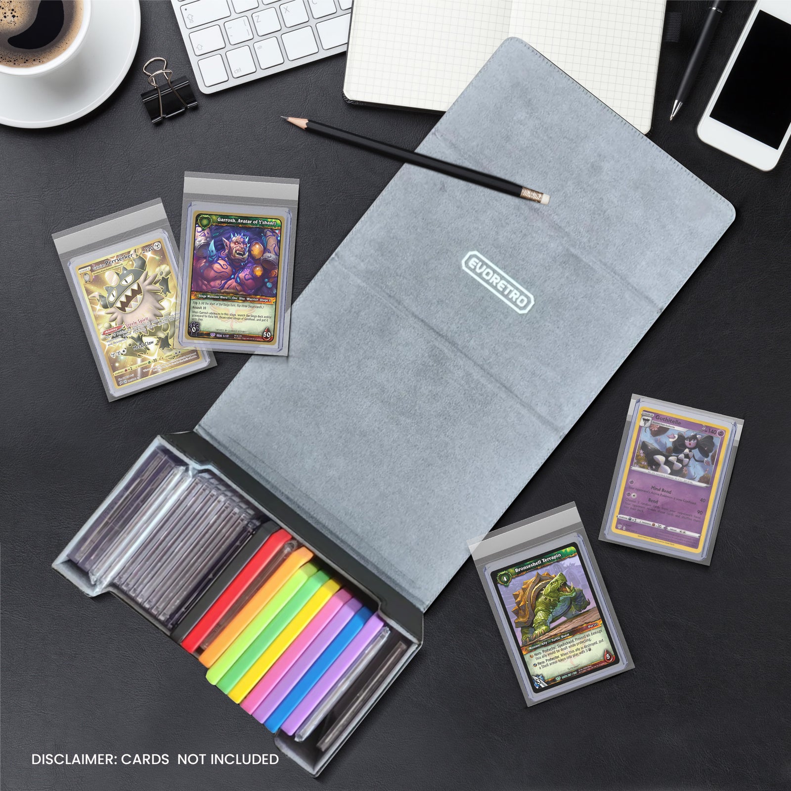 Open graded card holder with colorful slabs on black desk, surrounded by trading cards, notebook, coffee, and phone