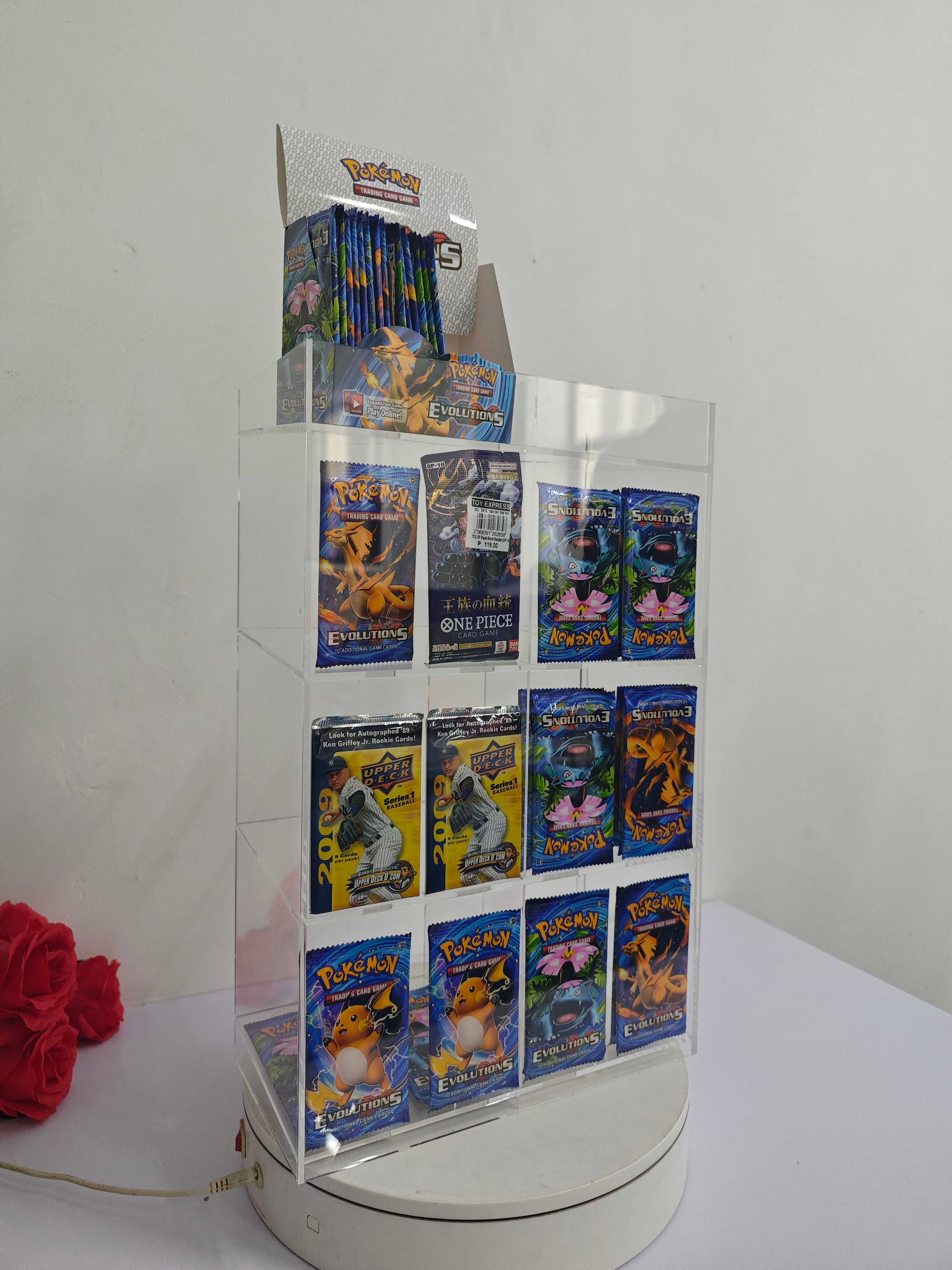 Acrylic display case with Pokemon trading card packs on a white background