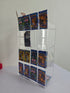 Acrylic display case with Pokemon trading cards on a white surface.