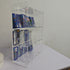 Side view of a clear acrylic display stand holding a variety of trading card booster packs.