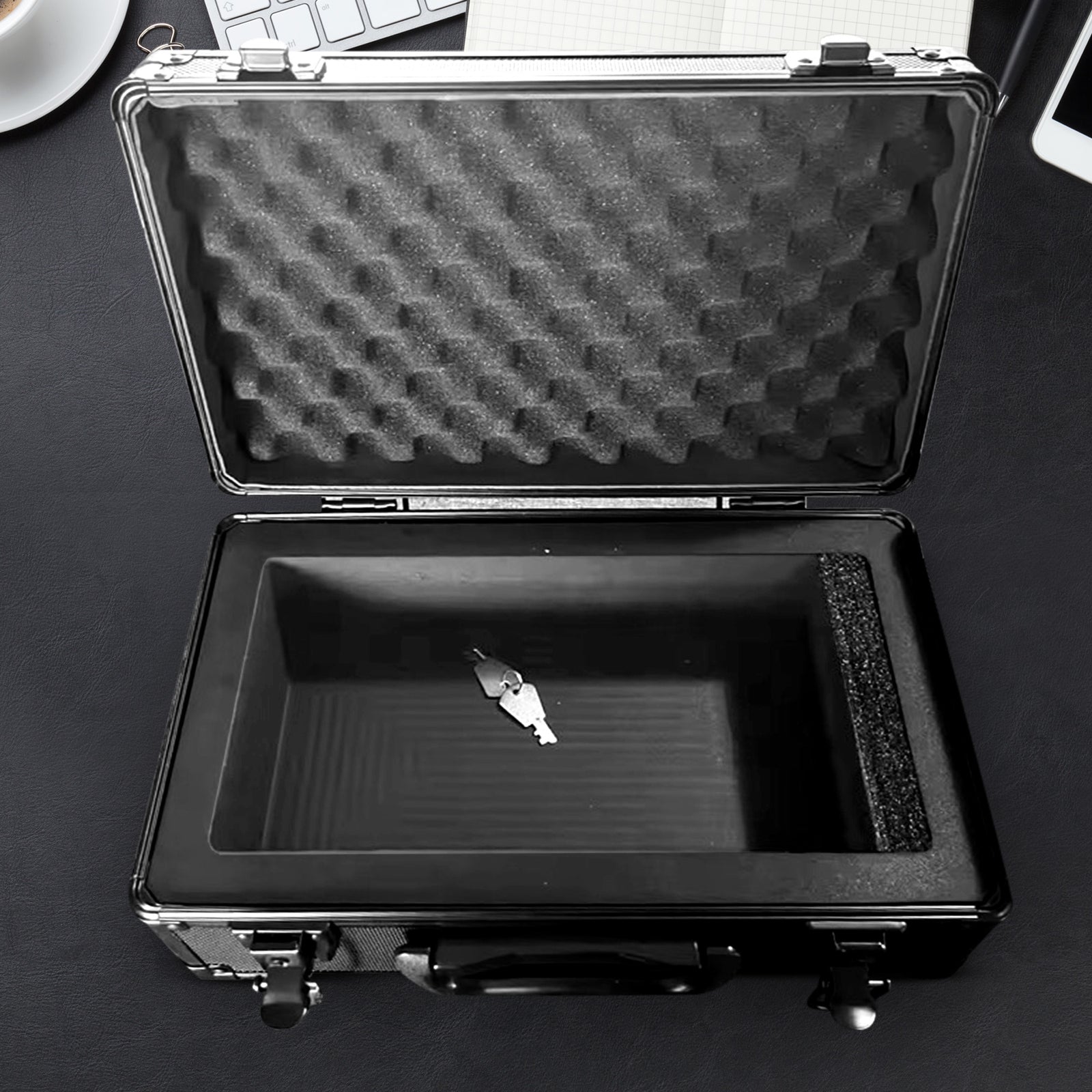 Black metal case with foam lining shown on a black surface