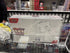 Pokémon Meowth-themed box inside acrylic case on a store display shelf.