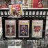 Collection of sports trading cards in a display case with various card packs in the background.
