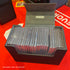 Collection of cards in a black box with EVORETRO branding on a red surface.