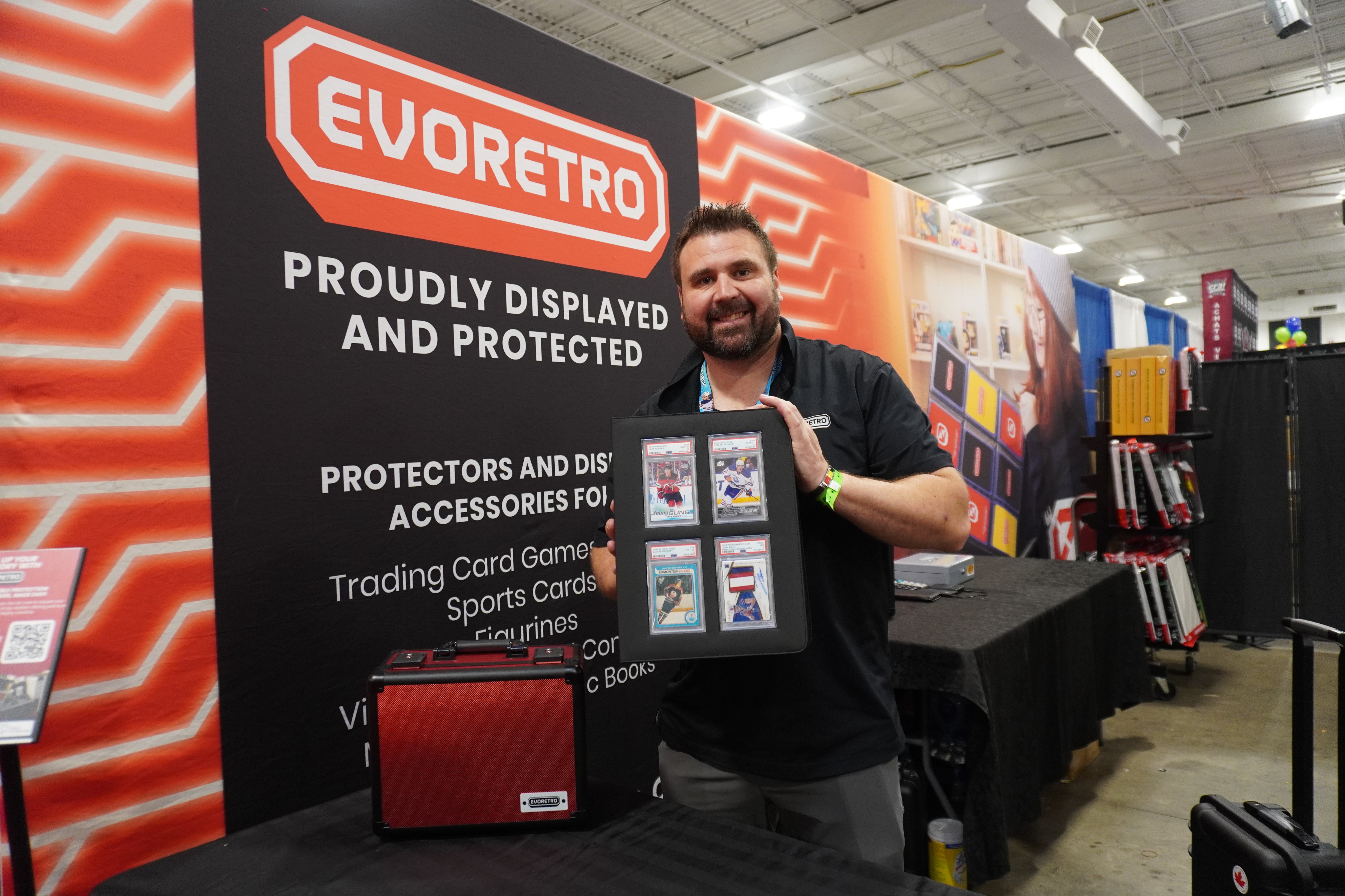Eric showcasing EVORETRO slab binder at the event, front-facing view with sports cards displayed in the card slots.