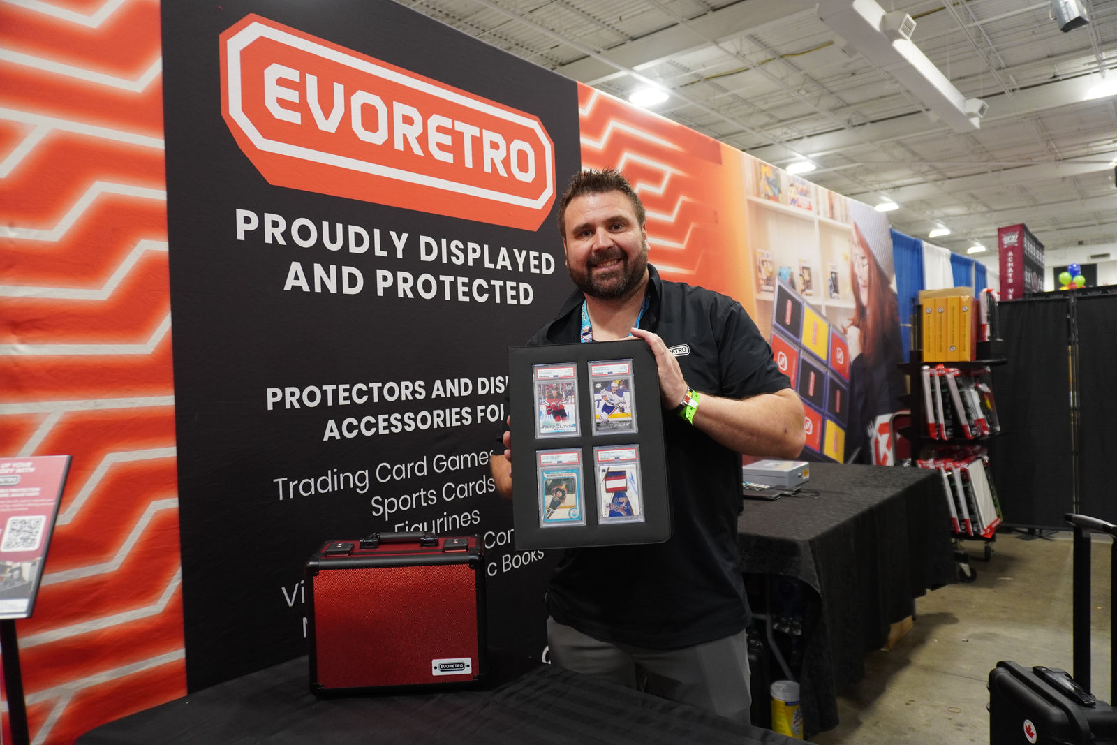 Eric showcasing EVORETRO slab binder at the event, front-facing view with sports cards displayed in the card slots.